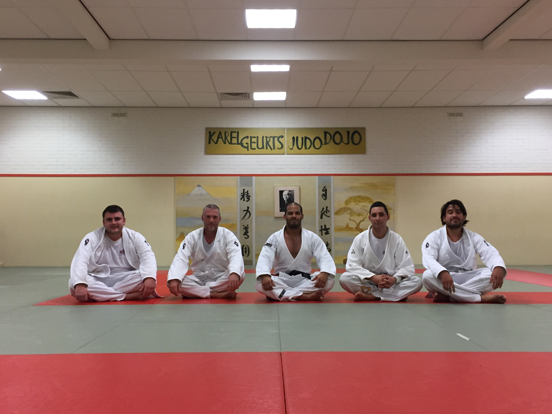 Partisla group sitting on the mats in the dojo